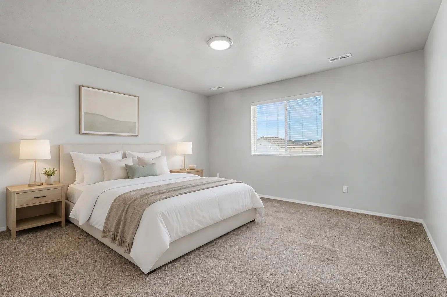 Carpeted primary bedroom with a window and neutral walls