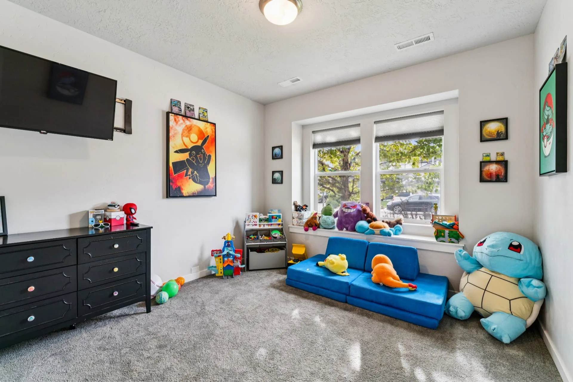 Additional carpeted bedroom with two windows, currently used as a children's play room